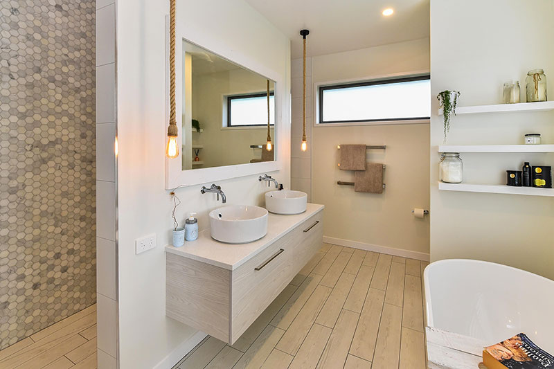 Beautiful light ensuite with marble mosaic feature wall in large walk through double shower, rope pendents & freestanding bath