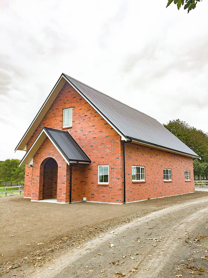 Victorian style barn/shed with living quarters. Red brick. Church look