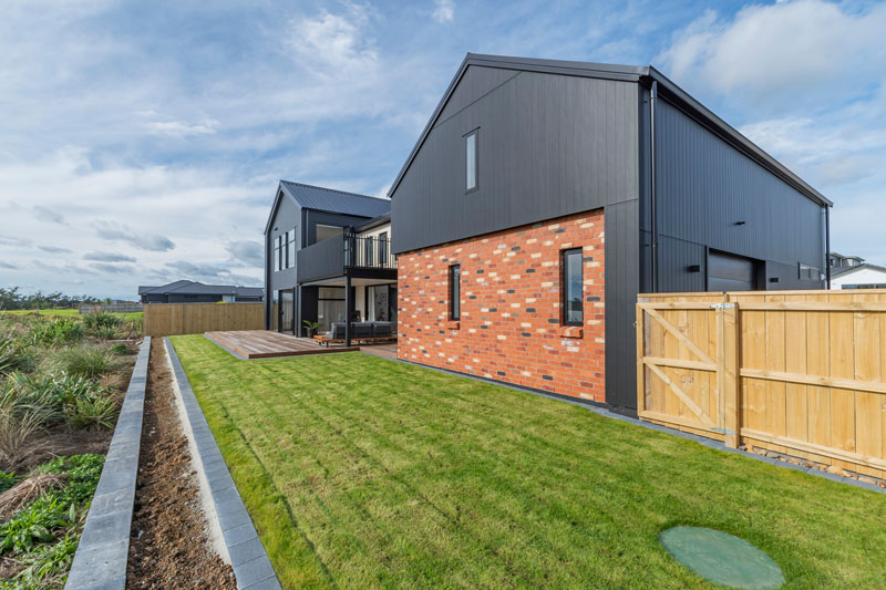 Back of designer home with Black Axon panel and Red recycled brick features