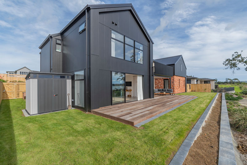 Back of designer home with Black Axon panel, white brick and Red recycled brick features