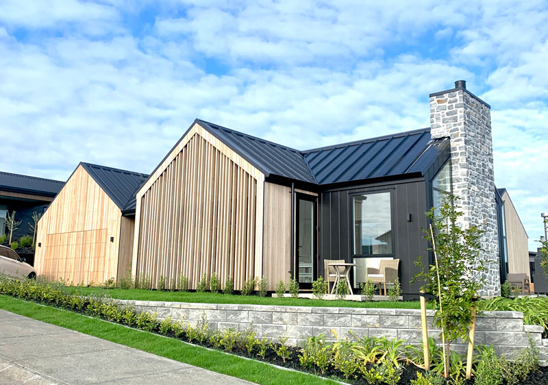 Paerata Rise Showhome schist fireplace truwood timber cladding out of eden landscaping