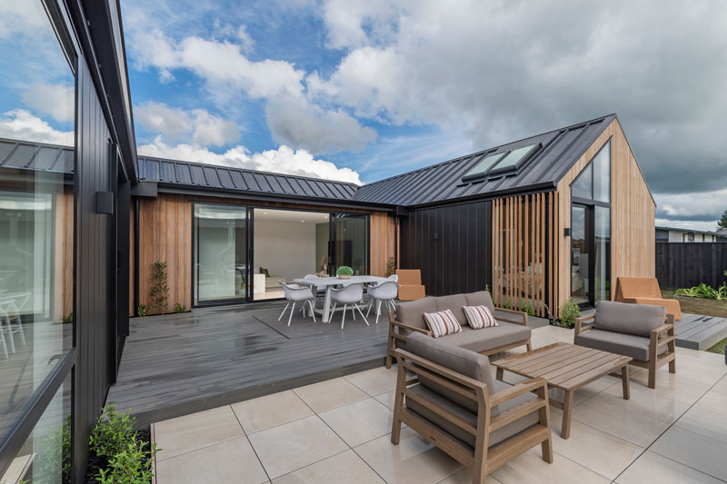 Paerata Rise Showhome back deck with outdoor couch truwood cladding skylights