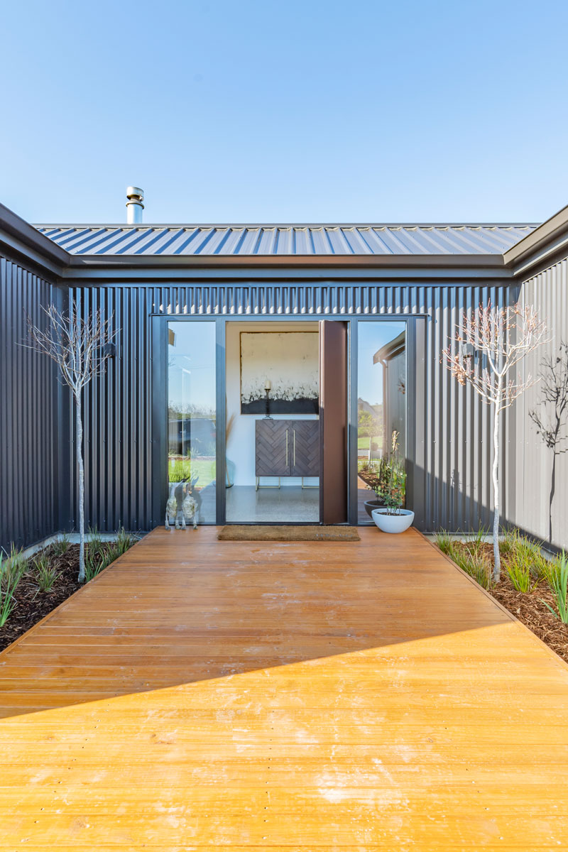 Beautiful welcoming entrance with timber decking on award winning pavillion style home