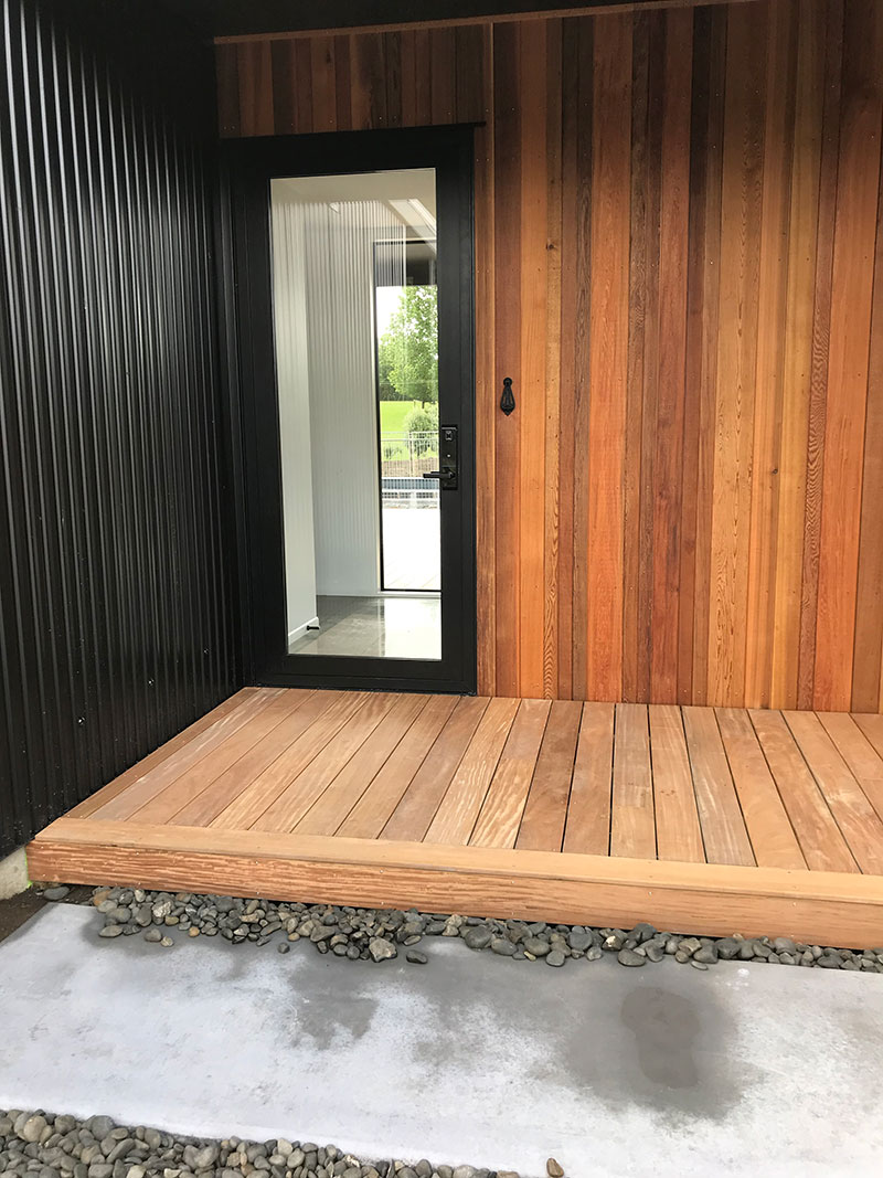 glass front door, entarance, on cedar and coloursteel home