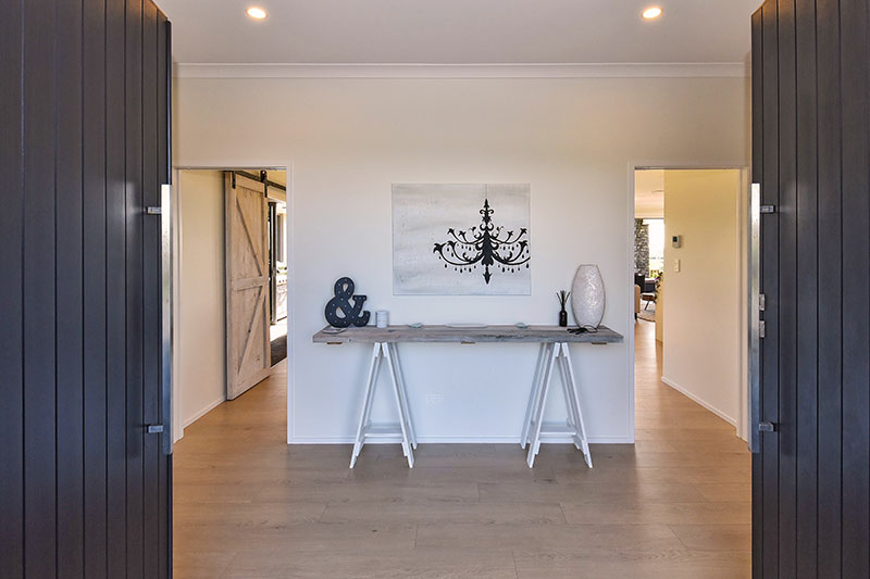 double door entrance into spacious, white & timber coastal / scandinavian style entry hall with trestle style hall table