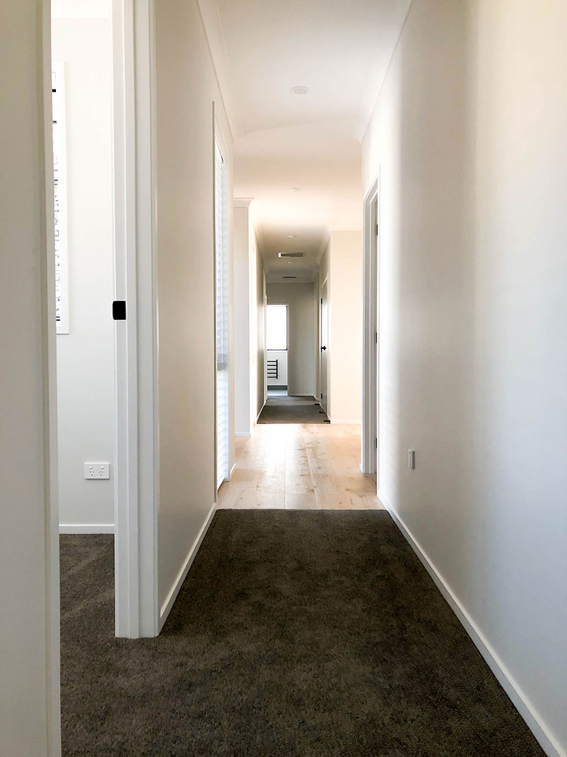 Large spacious hallway with Hurford French Oak Timber Floor and charcoal carpet