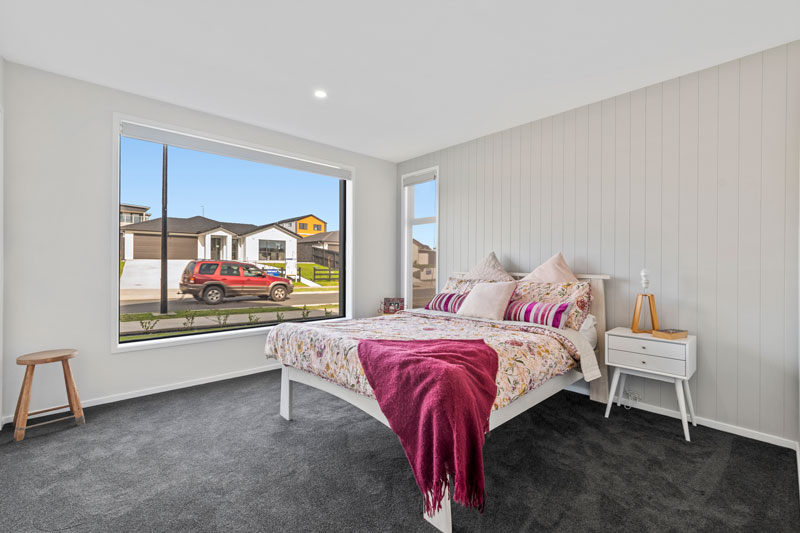 large spare bedroom with feature wall in Glenbrook home in Franklin