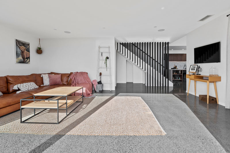open living space with polished concrete floors, black timber linear balustrade in designer home in Franklin