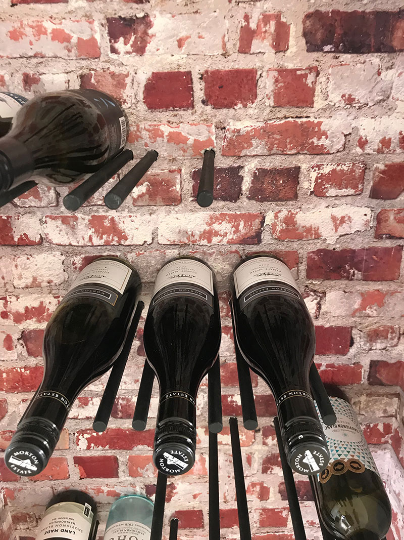 rustic brick wine cellar cupboard with metal rods 