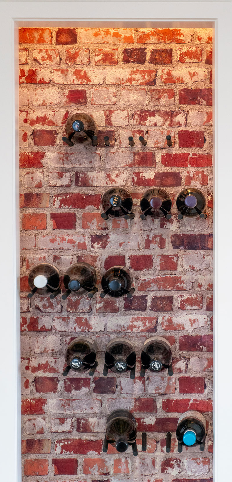 Rustic Wine cellar / cupboard with red brick wallpaper and steel rods