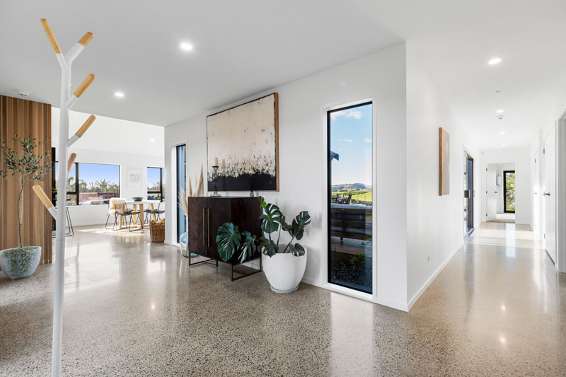 beauitful entrance way with timber cladding and polished concrete floors in award winning home in Franklin