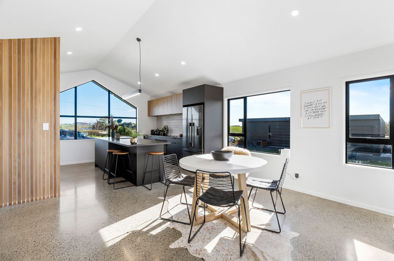 beauitful dining and kitchen space in award winning designer home in Franklin with timber feature wall