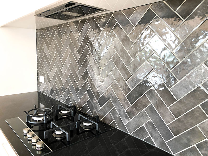 Black, white and grey kitchen with charcoal artisan subway tiled splashblack from Tile Space