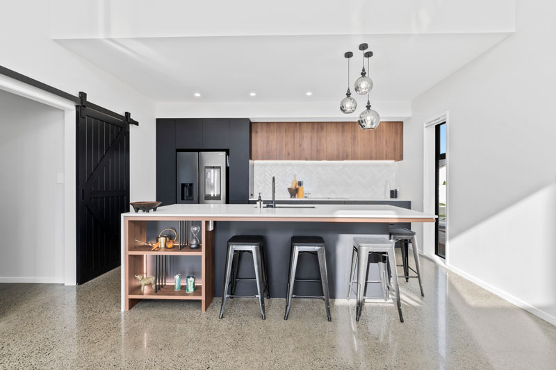 Gorgeous kitchen with black cabintry marble benchtop, and timber accents in designer home in Glenbrook