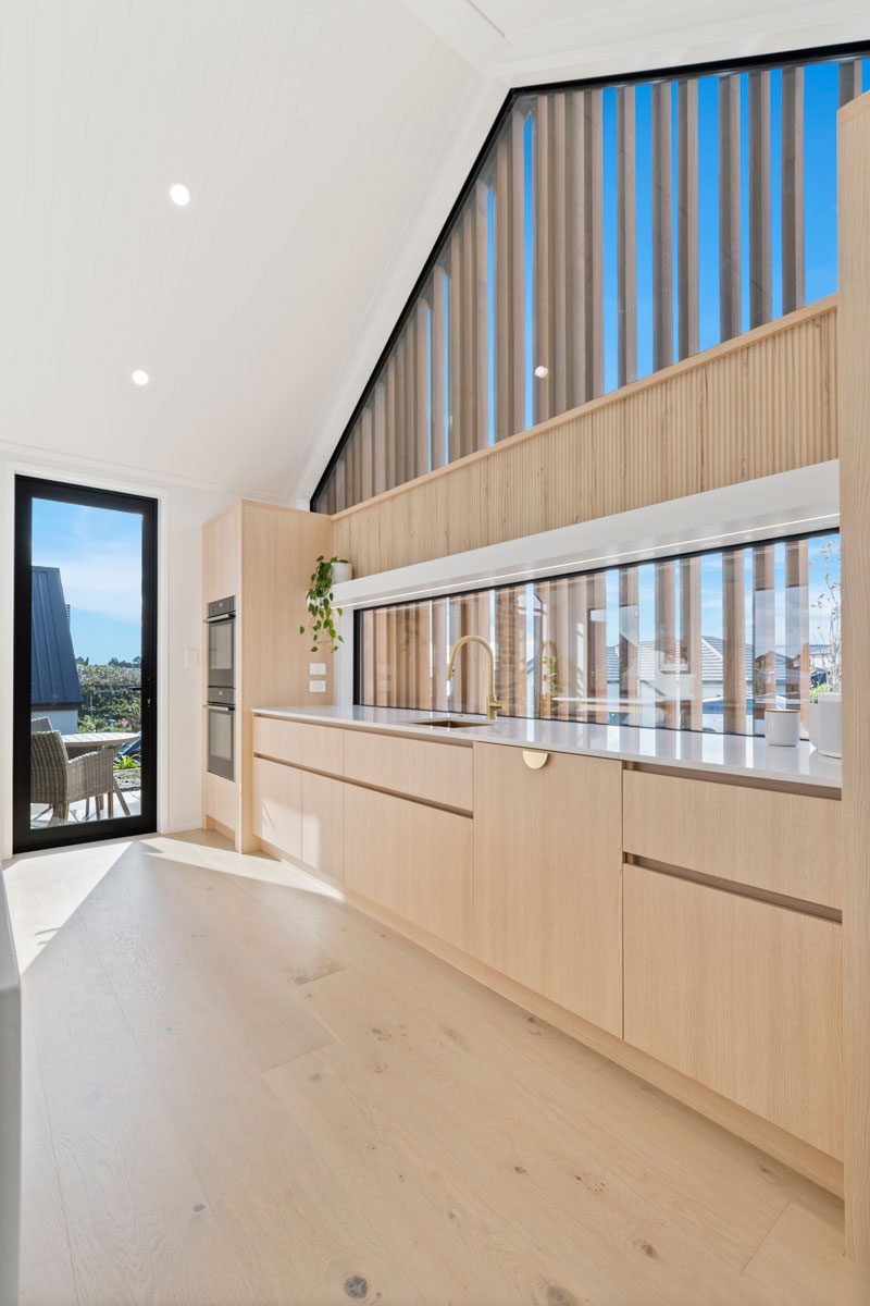 Gorgeous light timber scandinavian kitchen with brass fittings, marble top in Paerata Rise showhome