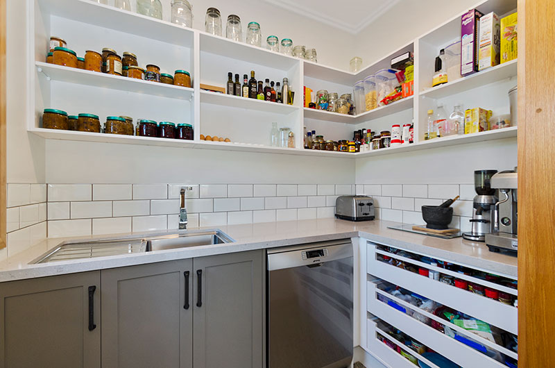 Large butlers pantry in colonial style kitchen in award winning home. Expansive storage, large sink & white subway splash back