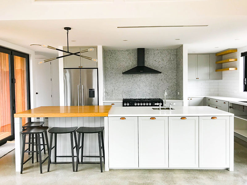 Modern & traditional style kitchen with timber bench & shelves, black falcon stove and mosaic splashback